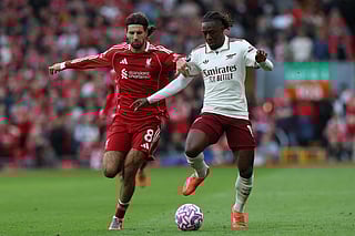 Arsenal's English midfielder #10 Eberechi Eze (R) is challenged by Liverpool's Hungarian midfielder #08 Dominik Szoboszlai (L) during the English Premier League football match between Liverpool and Arsenal at Anfield in Liverpool, north west England on August 31, 2025.
