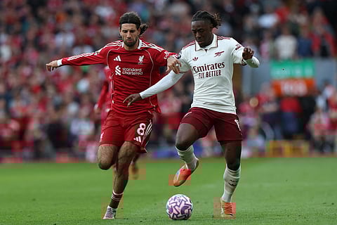 Liverpool's Dominik Szoboszlai (left) shoots to score his sides first goal during the English Premier League match against Arsenal in Liverpool, England, on August 31, 2025.