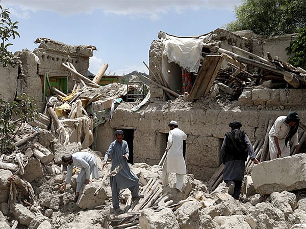 Residents at one of the buildings damaged by the earthquake.