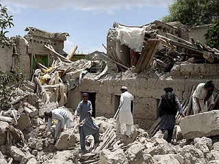 Residents at one of the buildings damaged by the earthquake.
