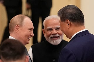 Indian Prime Minister Narendra Modi (C) talks with Russian President Vladimir Putin (L) and Chinese President Xi Jinping ahead of the Shanghai Cooperation Organisation (SCO) Summit 2025 at the Meijiang Convention and Exhibition Centre in Tianjin on September 1, 2025.