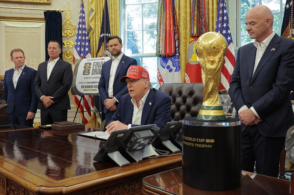 US President Donald Trump speaks in the Oval Office while FIFA President Gianni Infantino (R), and Vice President JD Vance (3rd L) look on August 22, 2025 in Washington, DC. Trump announced the FIFA World Cup 2026 draw will take place at The Kennedy Center.