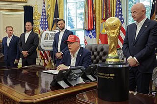 US President Donald Trump speaks in the Oval Office while FIFA President Gianni Infantino (R), and Vice President JD Vance (3rd L) look on August 22, 2025 in Washington, DC. Trump announced the FIFA World Cup 2026 draw will take place at The Kennedy Center.