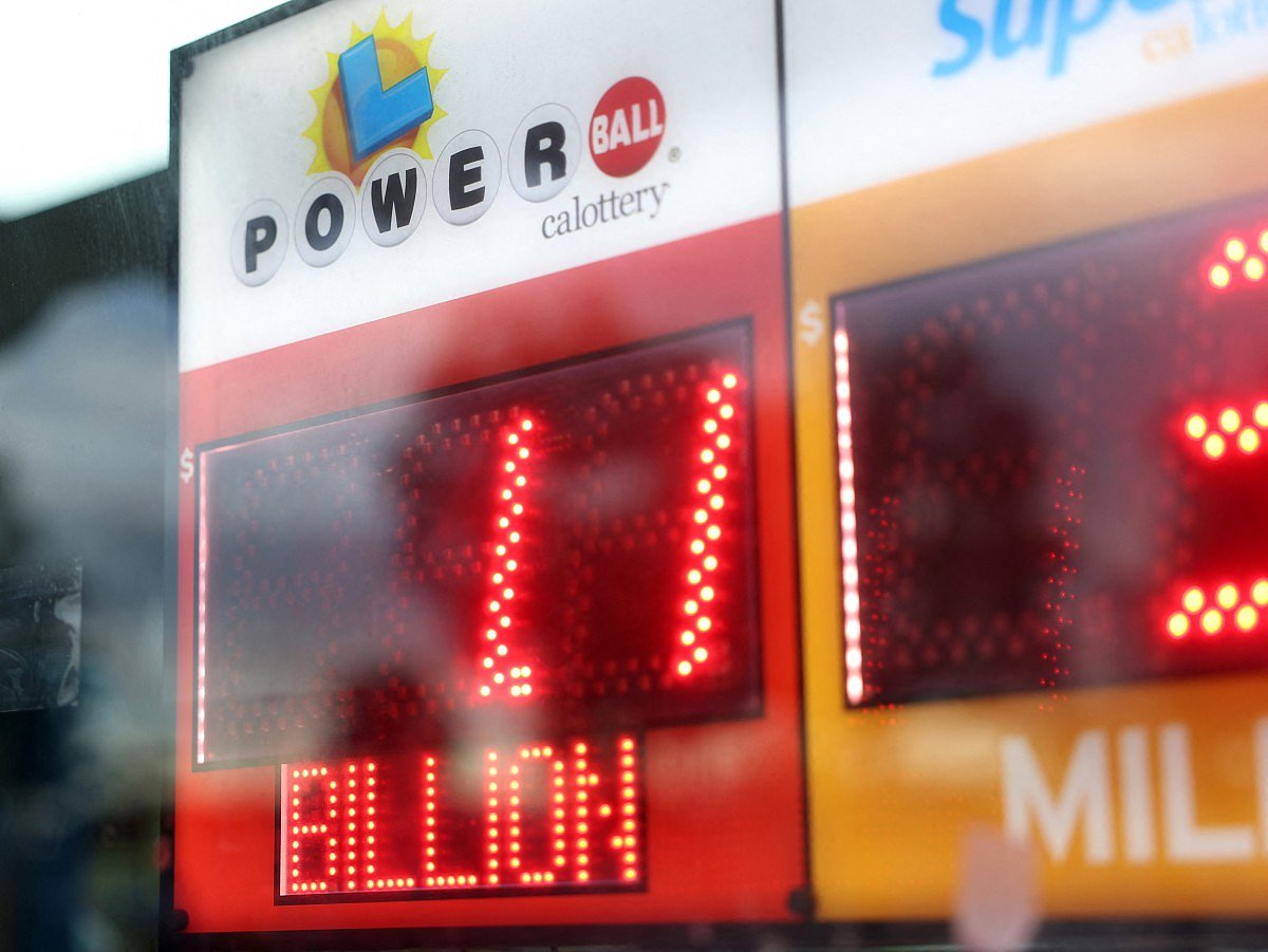 A sign displays a $1.1 billion Powerball jackpot as people line up to buy tickets ahead of the Labor Day drawing at Bluebird Store in Hawthorne, California, on September 1, 2025.