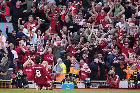 Liverpool's Dominik Szoboszlai celebrates after scoring his sides first goal during the English Premier League soccer match between FC Liverpool and FC Arsenal in Liverpool, England, Sunday, Aug. 31, 2025.