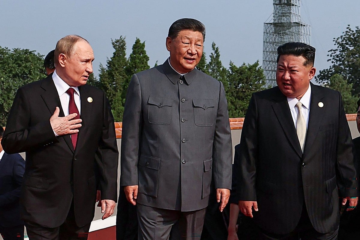 Russia's President Vladimir Putin walks with China's President Xi Jinping and North Korea's leader Kim Jong Un.