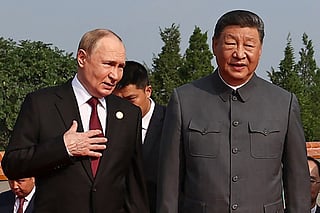 Russia's President Vladimir Putin (L) walks with China's President Xi Jinping before a military parade.