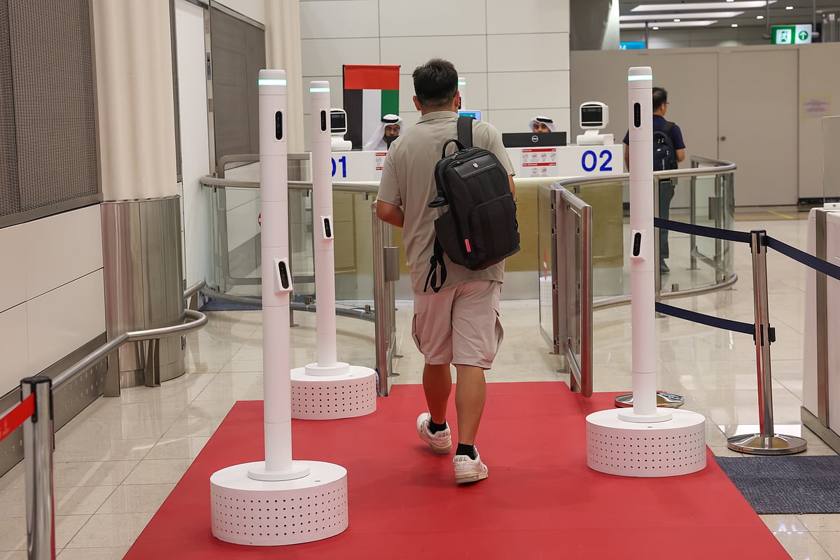 Passengers using Smart Tunnel, a biometric immigration system at Dubai International Airport Terminal-3 that allows passengers to complete passport control in seconds withl biometric recognition system.  