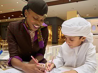 Airline staff interact with children visiting the Etihad Airlines activation in Galleria Mall, Abu Dhabi. 