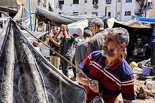 People inspect damages at a tent encampment that was sheltering displaced people, after it was hit by Israeli bombardment, near Shifa Hospital in Gaza City. File photo taken on September 4, 2025.