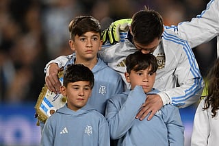 Argentina's forward #10 Lionel Messi hugs his sons ahead of the 2026 FIFA World Cup South American qualifiers football match between Argentina and Venezuela at the Mas Monumental stadium in Buenos Aires on September 4, 2025.