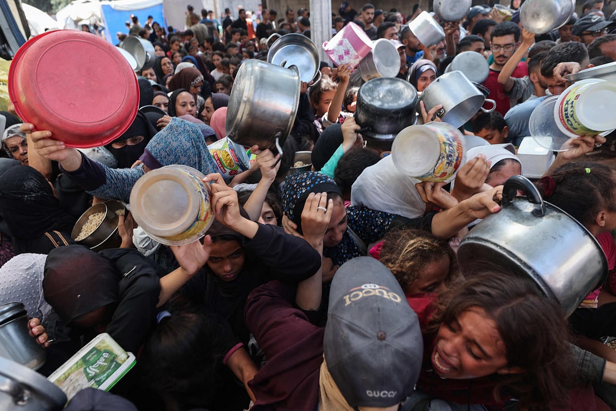 Palestinians shove to receive a meal from a charity kitchen in the Nuseirat refugee camp in the Israel-besieged Gaza Strip on September 4, 2025, where the UN has declared famine after nearly two years of war.  