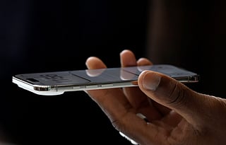 An attendee inspects a new Apple iPhone Air during an Apple special event at Apple headquarters on September 9, 2025 in Cupertino, California.