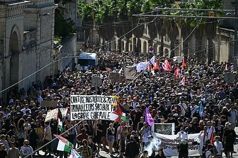 Protesters attend a demonstration part of the "Bloquons tout" ("Let's block everything") protest movement, at the Place de la Comedie, in Montpellier, southern France, on September 10, 2025.