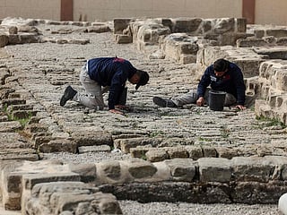 Palestinian students work at the archaeological site of Saint Hilarion, also known as Tell Umm Amer, in the central Gaza Strip on March 7, 2023. 