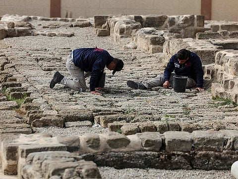 Palestinian students work at the archaeological site of Saint Hilarion, also known as Tell Umm Amer, in the central Gaza Strip on March 7, 2023. 