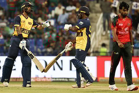 Sri Lanka's Kamil Mishara (L) greets his teammate Kusal Perera during the Asia Cup 2025 Twenty20 international cricket match between Bangladesh and Sri Lanka at the Sheikh Zayed Cricket Stadium in Abu Dhabi on September 13, 2025 