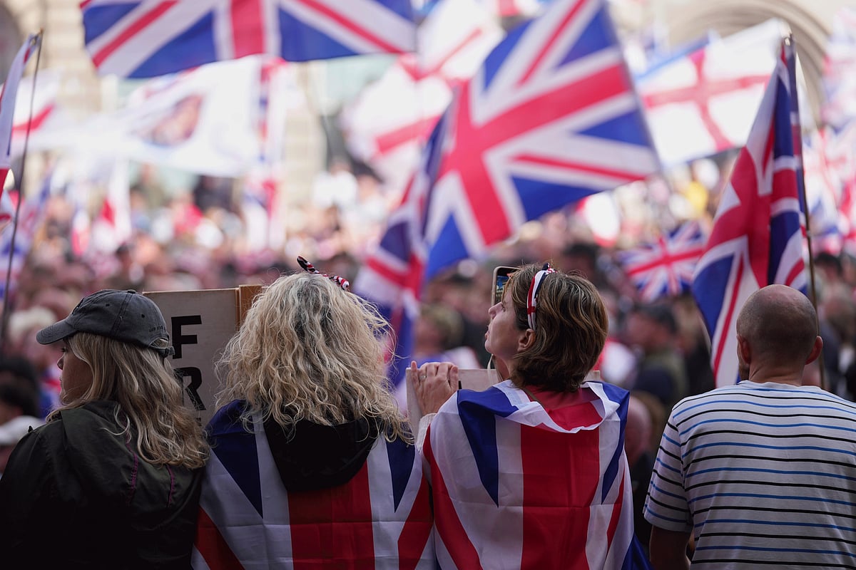 People demonstrate during the Tommy Robinson-led Unite the Kingdom march and rally, in London on September 13, 2025.  