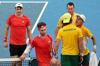 Australia’s team captain Lleyton Hewitt (TOP) watches players Rinky Hijikata (R) and Jordan Thompson react after winning the second set against Belgium’s Sander Gille and Joran Vliegen (L) during their Davis Cup second-round qualifier doubles tennis match at Ken Rosewall Arena in Sydney on September 14, 2025.