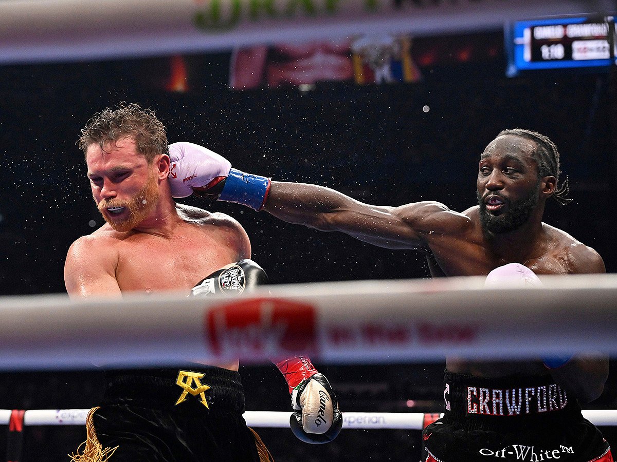 Terence Crawford, right, punches Canelo Alvarez during an undisputed super middleweight championship boxing match in Las Vegas.