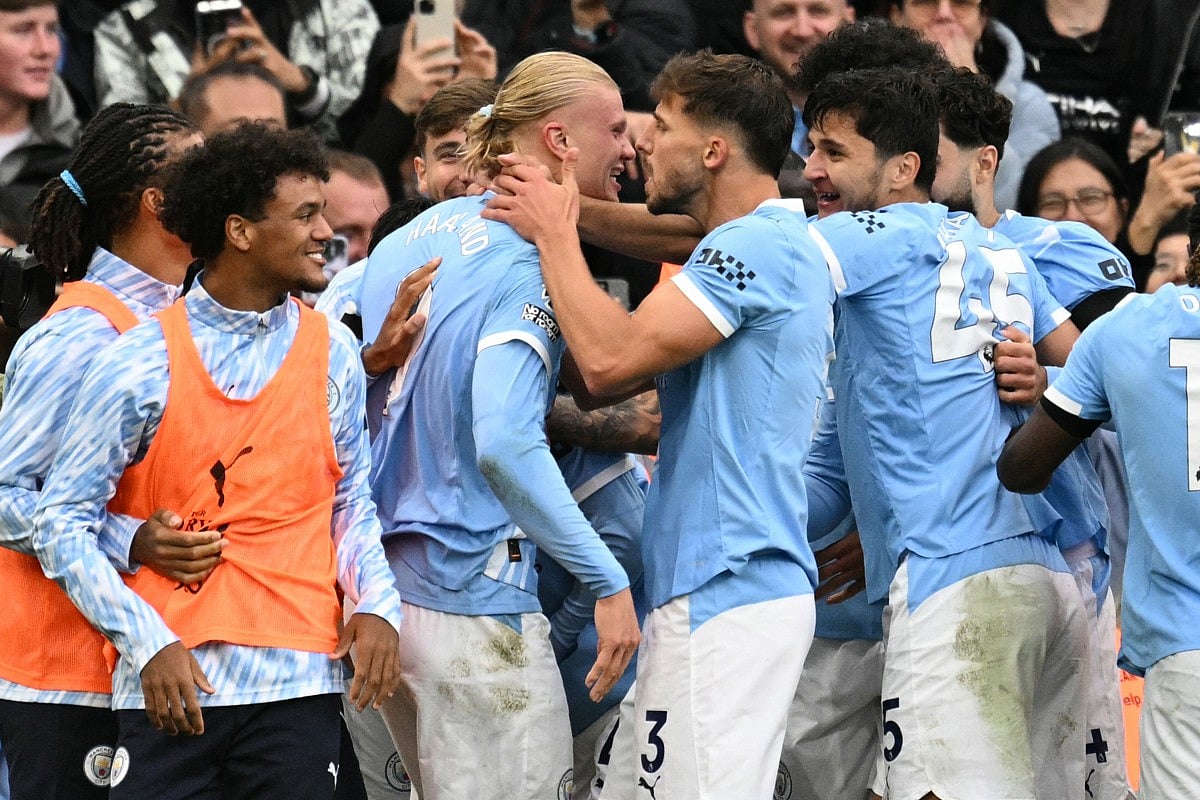 Manchester City's Norwegian striker Erling Haaland (CL) celebrates scoring their second goal during the English Premier League football match against Manchester United at the Etihad Stadium in Manchester, north west England, on September 14, 2025.