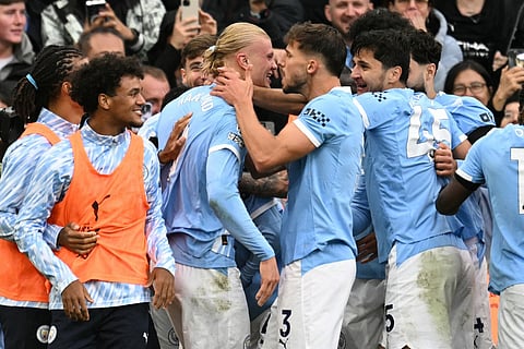 Manchester City's Norwegian striker Erling Haaland (CL) celebrates scoring their second goal during the English Premier League football match against Manchester United at the Etihad Stadium in Manchester, north west England, on September 14, 2025.