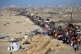 Displaced Palestinians move with their belongings southwards on a road in the Nuseirat refugee camp area in the central Gaza Strip.