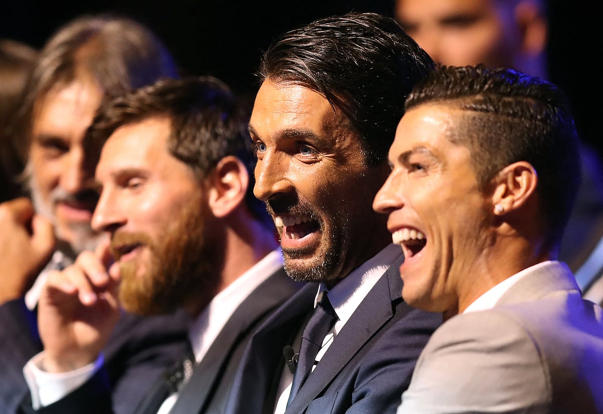 Real Madrid's Portuguese forward Cristiano Ronaldo (R) shares a light moment with Juventus's Italian goalkeeper Gianluigi Buffon (C) and Barcelona's Argentinian forward Lionel Messi (C/L) as they wait ahead of the awarding of the title of "Best Men's Player in Europe" at the conclusion of UEFA Champions League group stage draw ceremony in Monaco on August 24, 2017.