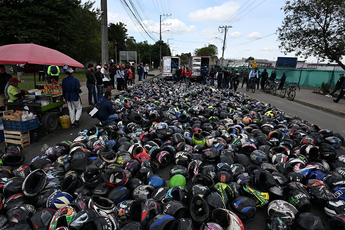 Motorcyclists block the street with helmets during a protest against transport politics of Bogota's mayor Carlos Fernando Galan in Bogota on September 16, 2025.