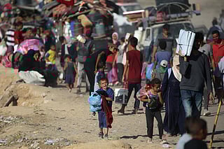 Displaced Palestinians move with their belongings southwards on a road in the Nuseirat refugee camp area in the central Gaza Strip following renewed Israeli evacuation orders for Gaza City.