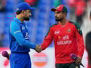 Afghanistan's captain Rashid Khan, left, and Bangladesh's captain Litton Das shake hands after the toss during the Asia Cup Cricket match at Zayed Cricket Stadium in Abu Dhabi, on Tuesday, September 16, 2025. 