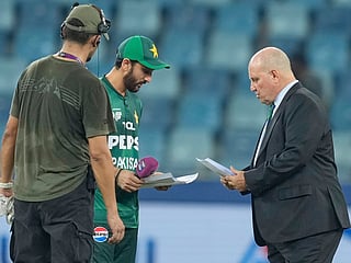 
Pakistan's captain Salman Agha shares team list with match referee Andy Pycroft at the toss during the Asia Cup cricket match against the UAE at Dubai International Cricket Stadium, on Wednesday, September 17, 2025. 
