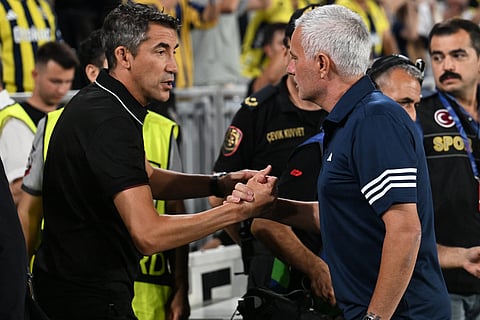 Fenerbahce's Portuguese head coach Jose Mourinho (R) and Benfica’s Portuguese head coach Bruno Lage (L) shake hands ahead of the start of the UEFA Champions League play off first leg football match between Fenerbahce (TUR) and Benfica (POR) at the Fenerbahce Sukru Saracoglu Sport Complex in Istanbul on August 20, 2025. 