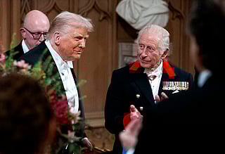 US President Donald Trump (L) reacts alongside Britain's King Charles III after delivering a speech during a State Banquet at Windsor Castle, in Windsor, on September 17, 2025, during the US President's second State Visit.