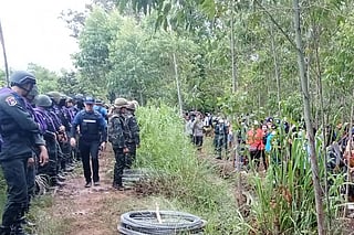 This handout photo taken and released by the Royal Thai Army on September 17, 2025 shows Thai Border Patrol Police (BPP) and police facing Cambodian people in a disputed area along the Cambodia-Thailand border in Sa Kaeo province.