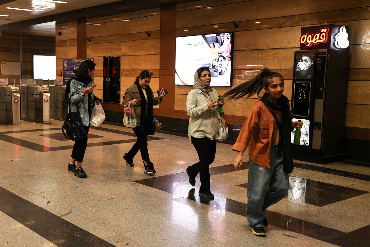 Women enter a station of the Shiraz Metro in northwestern Iran on September 17, 2025.