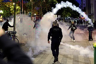 A tear gas canister is thrown as Police and demonstrators clash in Paris, on September 18, 2025, during a day of nationwide strikes and protests called by unions over France's national budget.