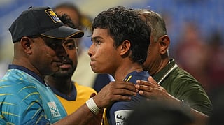 Dunith Wellalage being consoled by coach Sanath Jayasuriya.