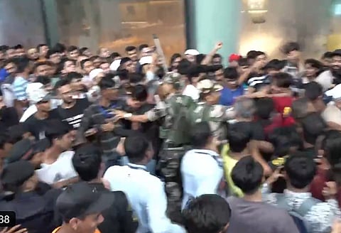 Early buyers fight for the new iPhone 17 as security steps in at Mumbai store