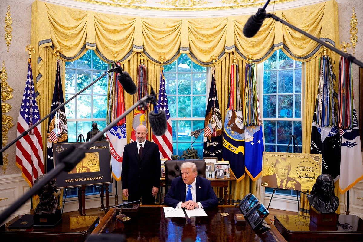 President Donald Trump, accompanied by US Commerce Secretary Howard Lutnick (L), speaks after signing an executive order in the Oval Office at the White House on September 19, 2025 in Washington, DC. Trump signed two executive orders, establishing the "Trump Gold Card" and introducing a $100,000 fee for H-1B visas.