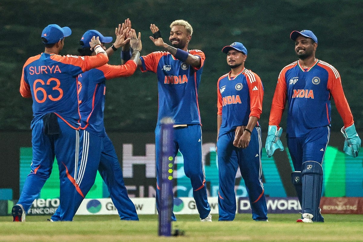 India's Hardik Pandya (C) celebrates with teammates after taking a catch to dismiss Oman's Aamir Kaleem.
