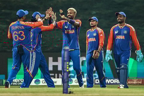 India's Hardik Pandya (C) celebrates with teammates after taking a catch to dismiss Oman's Aamir Kaleem.