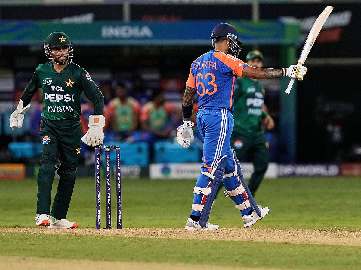 India's captain Suryakumar Yadav raises his bat to celebrate their win in the Asia Cup cricket match against Pakistan at Dubai International Cricket Stadium in Dubai, on Sunday, September 14, 2025. 