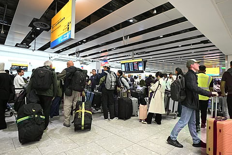 Travellers wait in the terminal at Heathrow Airport, west of London on September 20, 2025.