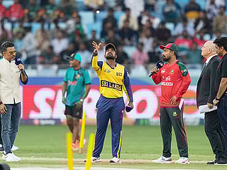 Bangladesh's captain Litton Das, right, watches as Sri Lanka's captain Charith Asalanka spins the coin at the toss ahead of the Asia Cup cricket match between them at Dubai International Cricket Stadium on Saturday, September 20, 2025.