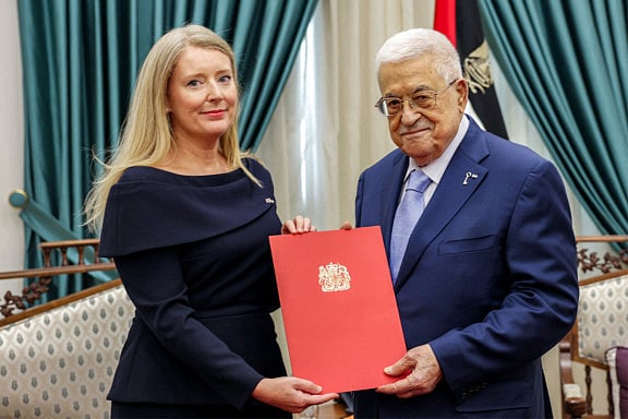Palestinian president Mahmoud Abbas receiving a written communique from Britain’s Consul-General to Jerusalem Helen Winterton at his headquarters in Ramallah in the occupied West Bank on September 21, 2025. 
The Palestinian president said on September 21 that Britain, Canada and Australia’s recognition of a Palestinian state was a necessary step toward lasting peace in the region. 