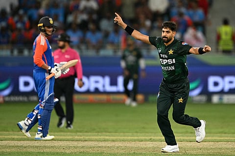 Pakistan's Haris Rauf (R) celebrates after taking the wicket of India's captain Suryakumar Yadav during the Asia Cup 2025 Super Four Twenty20 international cricket match between India and Pakistan at the Dubai International Stadium in Dubai on September 21, 2025.