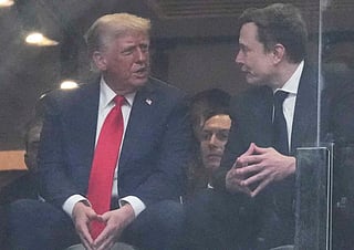 President Donald Trump, left, and Elon Musk talk during a memorial for Charlie Kirk, Sunday, Sept. 21, 2025, at State Farm Stadium in Glendale, Ariz.