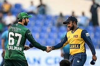 Pakistan's captain Salman Agha (L) shakes hands with his Sri Lankan counterpart Charith Asalanka during the toss before the start of the Asia Cup 2025 Super Four Twenty20 international cricket match between Pakistan and Sri Lanka at the Sheikh Zayed Cricket Stadium in Abu Dhabi on September 23, 2025.