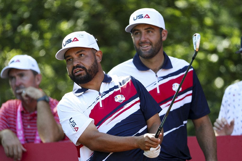 J. Spaun of Team United States tees off on the eighth hole as teammate Scottie Scheffler watches during a practice round prior to the Ryder Cup 2025 at Black Course at Bethpage State Park Golf Course on September 22, 2025 in Farmingdale, New York.